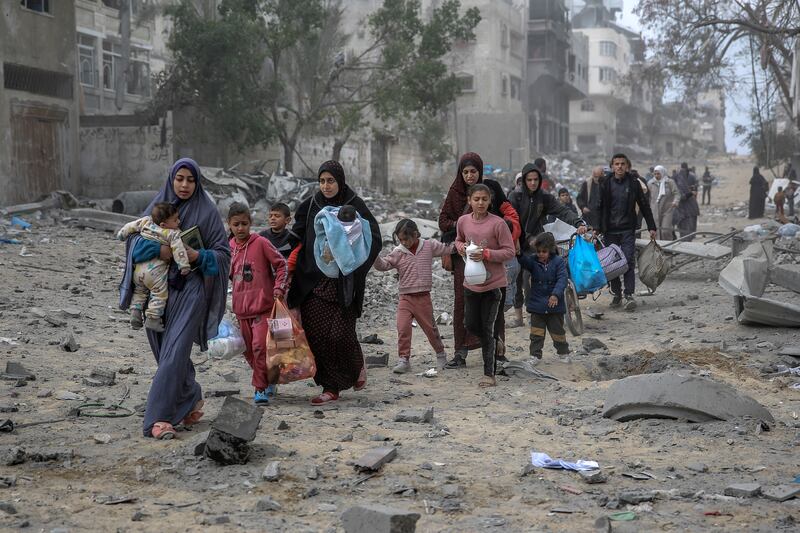 Palestinians flee the area after Israeli bombardment in central Gaza City. Photograph: AFP/Getty Images