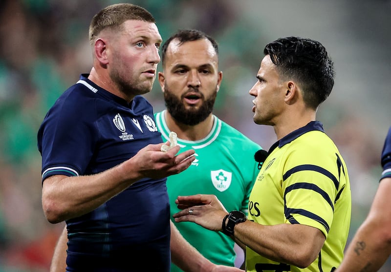 Referee Nic Berry talks with Scotland's Finn Russell during Saturday's Pool B match against Ireland. Photograph: Dan Sheridan/Inpho