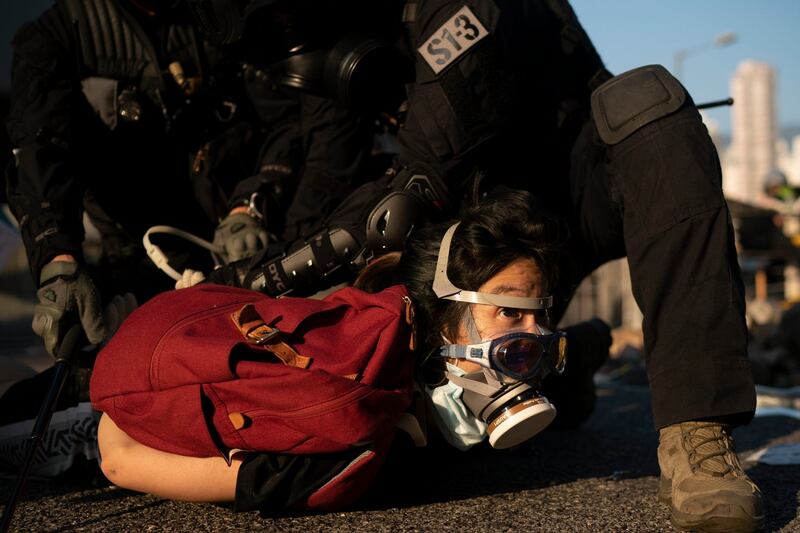 Police detain an anti-government protester in Hong Kong. Photograph: AP Photo/Felipe Dana