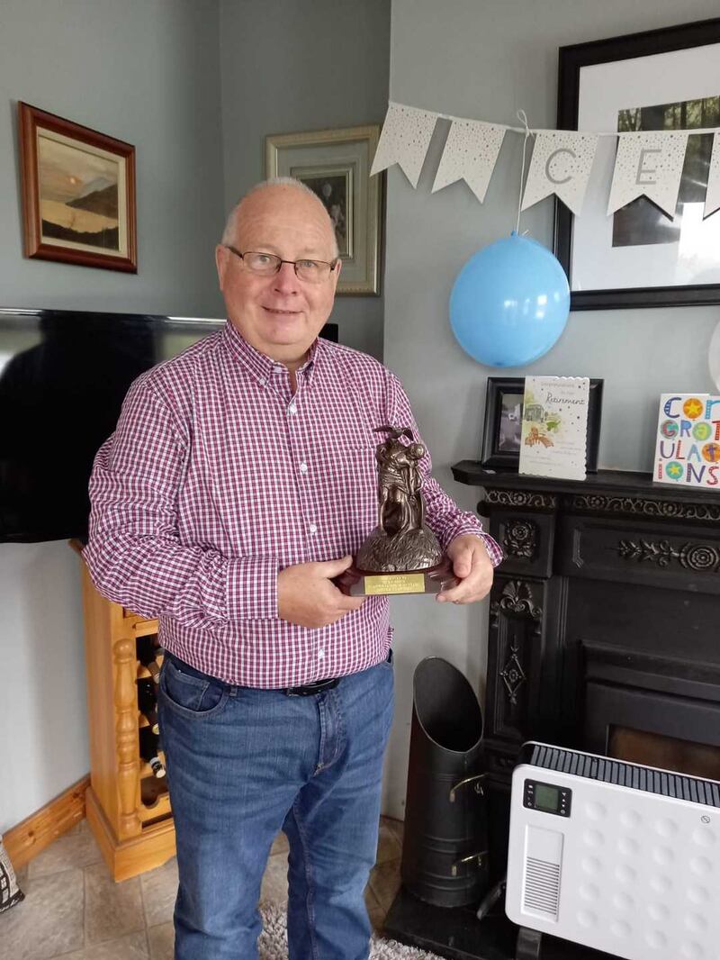 Nicky White with his gift from An Post colleagues on retiring after 20 years service.