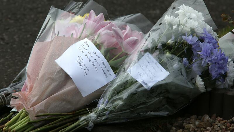 Flowers outside the house in Dalgety Bay in Fife where two-year-old twin boys have drowned after falling into a fish pond in a garden Photograph: Andrew Milligan/PA