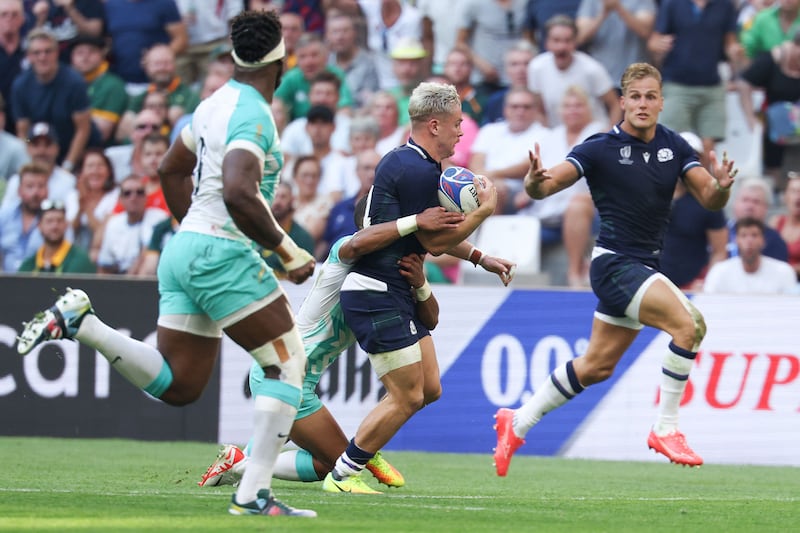 Scotland's wing Darcy Graham (C) runs with the ball as Scotland's wing Duhan van der Merwe (R) waits for a pass during the France 2023 Rugby World Cup Pool B match between South Africa and Scotland at Stade de Marseille in Marseille, southern France on September 10, 2023. (Photo by Pascal GUYOT / AFP) (Photo by PASCAL GUYOT/AFP via Getty Images)