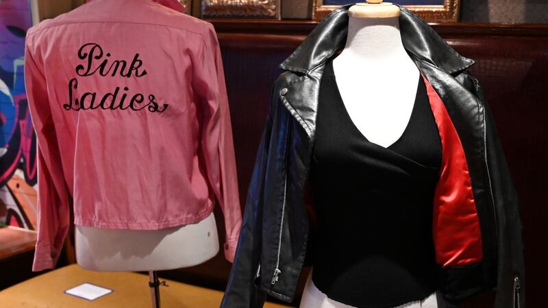 Olivia Newton-John’s famous black leather jacket and Pink Ladies jacket, both worn in Grease. Photograph: Timothy A. Clary/AFP via Getty