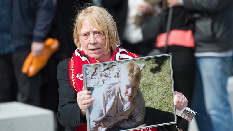 eMary Corrigan shows a photograph of her son Keith McGrath, who was 17 years old when he died in the Hillsborough disaster in 1989. Photograph: Peter Powell/EPA