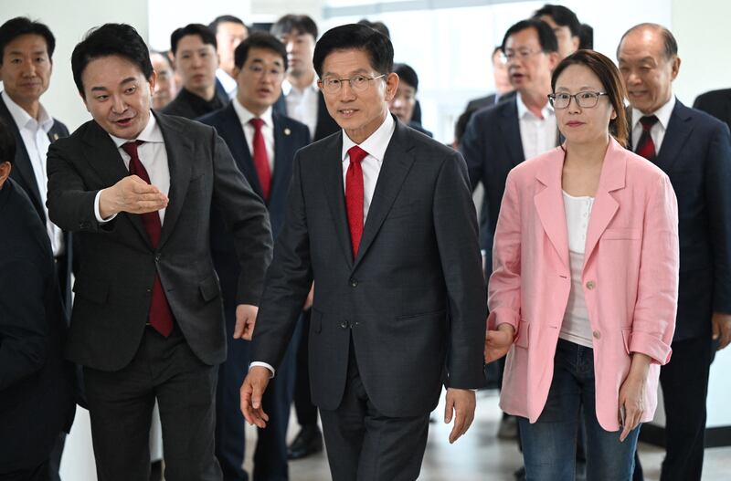 Kim Moon Soo, centre, the candidate for South Korea's People Power Party, arrives to cast his ballot during early voting for the presidential election on Thursday. Photograph: Jung Yeon-je/Getty