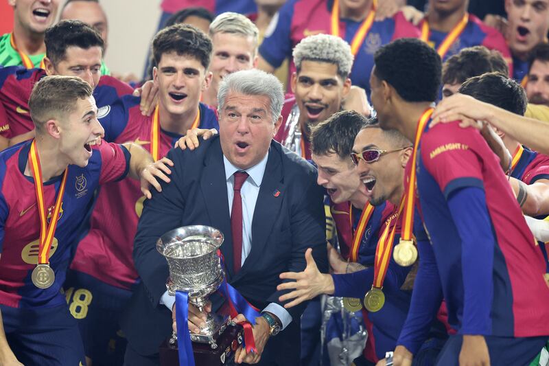 Barcelona's team president Joan Laporta celebrates with the trophy after winning the Spanish Super Cup final. Photograph: Haitham Al-Shukairi/AFP via Getty