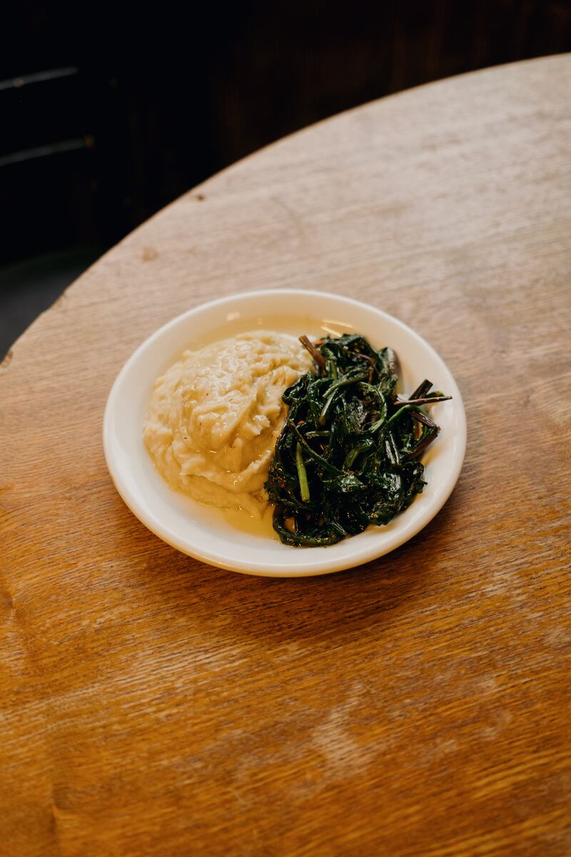 Stewed fava beans with sauteed bitter dandelion greens served at Assassination Custard. Photograph: Ellius Grace/the New York Times
                      