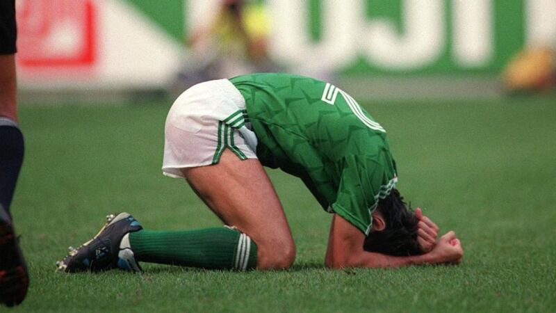 David O’Leary of the Republic of Ireland drops to his knees after scoring the winning penalty against Romania. Photograph: Billy Stickland/Inpho