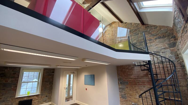 The exposed stone walls  have been combined with modern elements such as a steel staircase