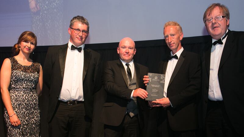 Richard Flood, Managing Director, Castlerock Contracting & Developments presents the Building of the Year - Office (Medium) award to the RKD Architects team.