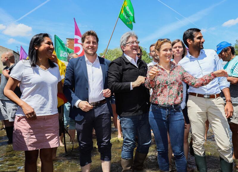 French leftist party La France Insoumise leader and leader of Nupes) Jean-Luc Melenchon, centre poses, flanked by Nupes members. 