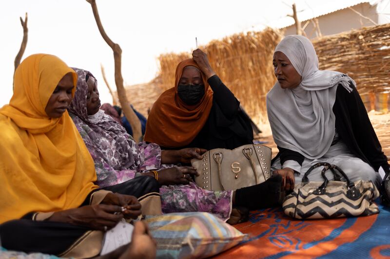 Aza Abkar, Rowda Mohammed, Tyseer Abdurhaman Hassan and Rowda Mohammed under a tree in the Aboutengue refugee camp in Chad. Photograph: Chris Maddaloni
