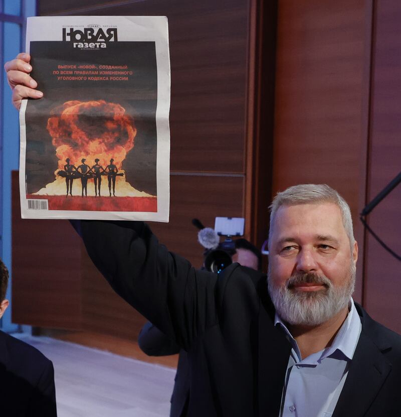Muratov holds up a copy of Novaya Gazeta. Photograph: Jason Szenes/EPA