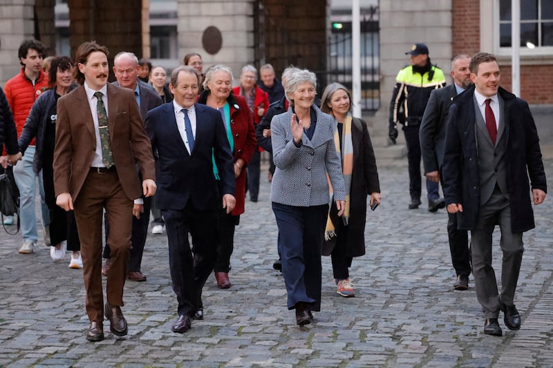 President-elect Catherine Connolly arrives at Dublin Castle accompanied by husband Brian McEnery and sons Brian and Stephen, and campaign manager Béibhinn O’Connor (wearing scarf). Photograph: Alan Betson