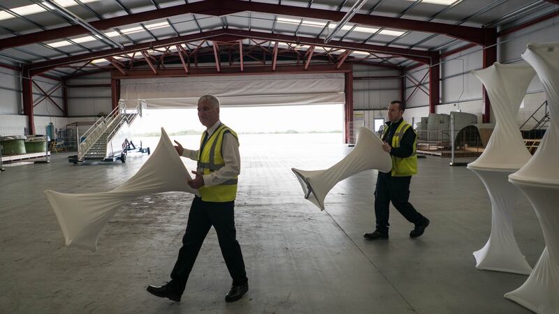 Ron Mellerick, fire security officer, and Sean Murtagh, security officer at Ireland West Airport Knock, moving tables in preparation for the visit of Pope Francis. Photograph: Keith Heneghan