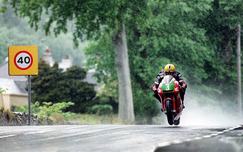 Despite the rain and his suffering from a recently amputated finger, Joey Dunlop raced to victory on his 250cc Honda in the 1998 Lightweight TT on the Isle of Man.  Photograph: Stephen Davison
