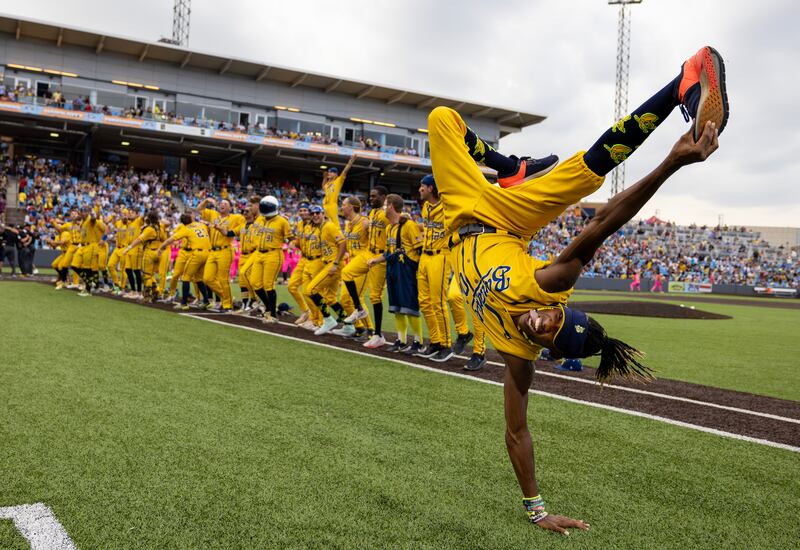 First base coach/dance instructor Maceo Harrison of the Savannah Bananas performs a dance routine in their game against the Party Animals at Richmond County Bank Ball Park in New York City.  Photograph:  by Al Bello/Getty Images
