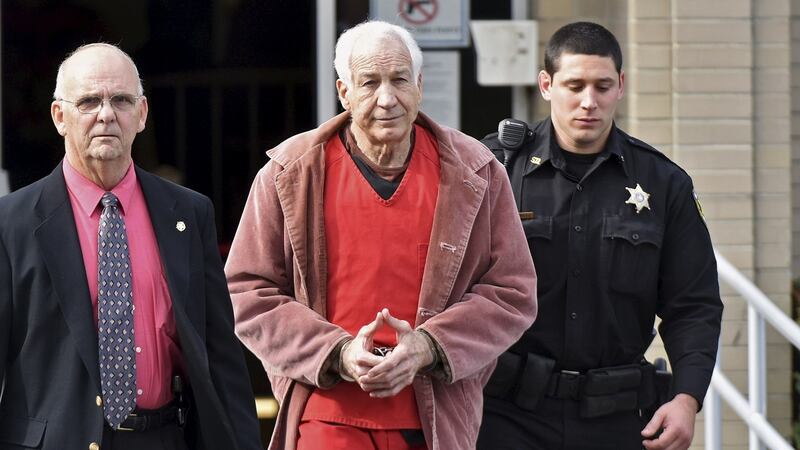 Convicted child molester Jerry Sandusky (centre):  the former assistant football coach at Penn State University is serving 30 to 60 years in prison. Photograph: Pat Little/ Reuters