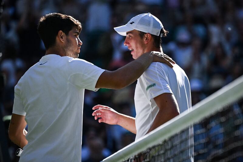 Carlos Alcaraz (left) and Oliver Tarvet at the end of the match, which Alcaraz won in straight sets. Photograph: Kirill Kudryavtsev/AFP via Getty Images