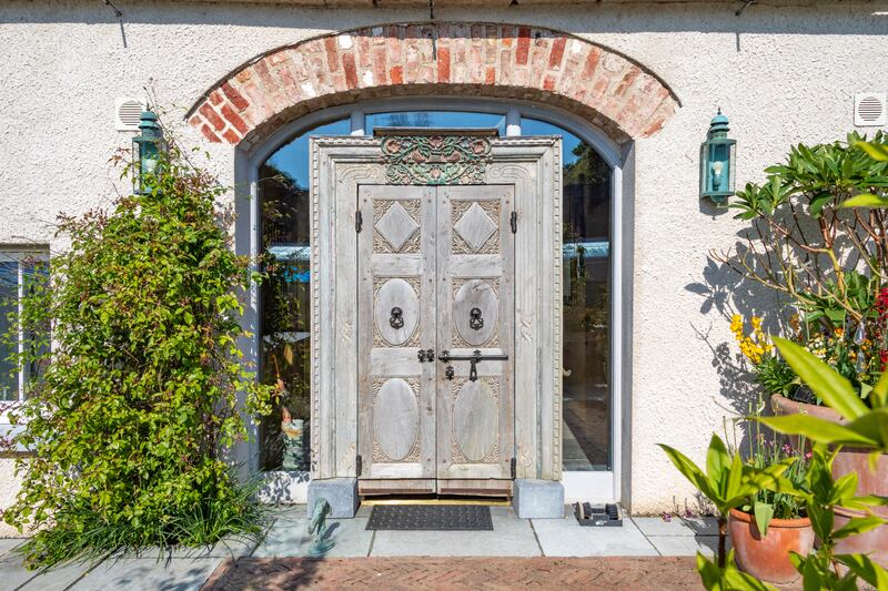 The main door to the farmhouse comes from an Indian temple