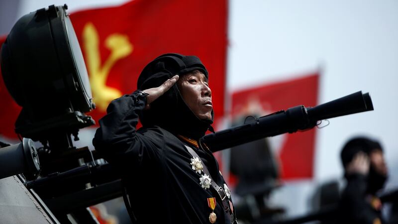 A soldier salutes from atop an armoured vehicle during Saturday’s military parade in Pyongyang. Photograph: Damir Sagolj/Reuters