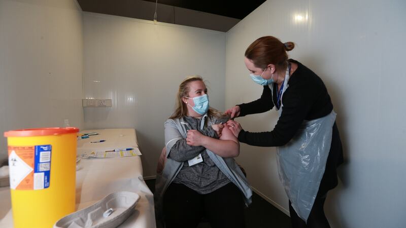 Vaccinator Niamh Donohoe administers home care assistant Aoife Thornton’s first dose of the Pfizer Covid-19 vaccine at The Helix mass vaccination centre. Photograph: Laura Hutton/The Irish Times