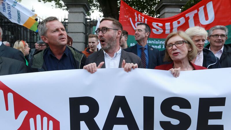 Solidarity’s Richard Boyd Barrett, Sinn Féin’s Eoin Ó Broin and Labour’s Jan O’Sullivan with representatives from trade unions and civil society groups outside Leinster House under the banner of Raise the Roof to demand that the Government implements a major motion on housing passed by the Dáil one year before. Photograph: Laura Hutton