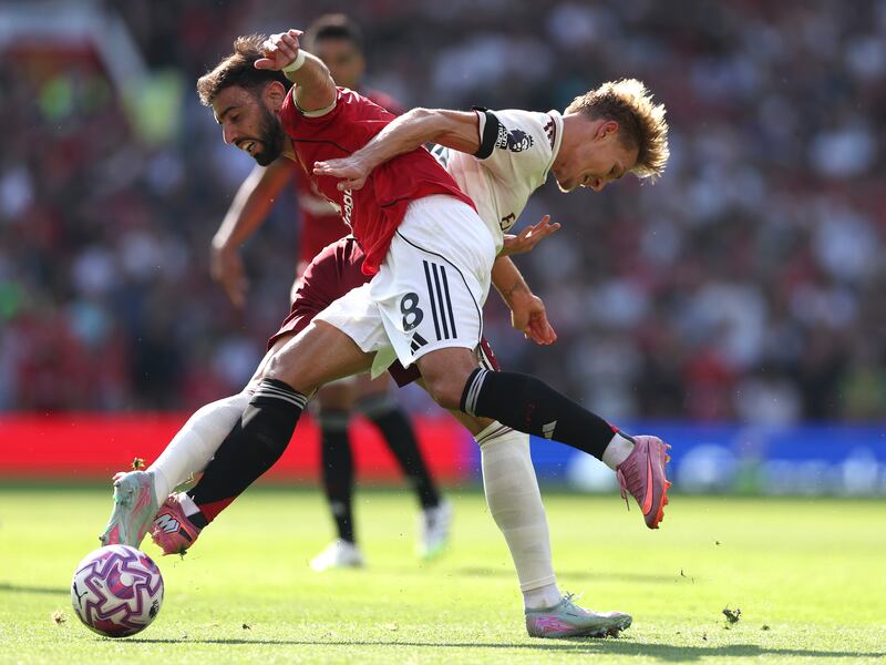 Arsenal captain Martin Odegaard challenges Manchester United captain Bruno Fernandes. Photograph: Stu Forster/Getty Images