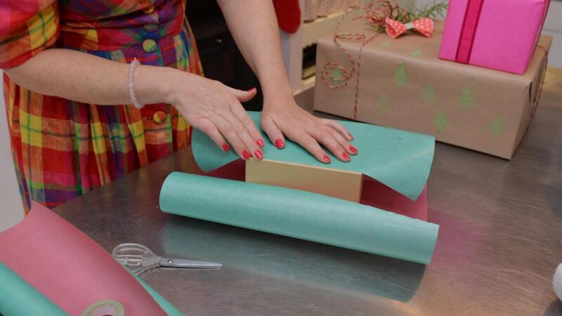 Step 2: Bring the paper right to the edge of the gift and then stick it down with a small bit of tape. Photograph: Alan Betson