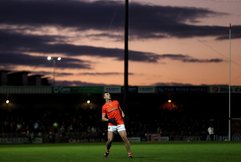 Armagh's Ethan Rafferty kicks a point as the sun sets in Tralee. Photograph: Bryan Keane/Inpho