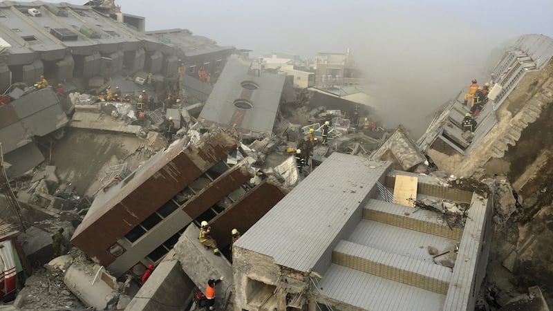Rescue personnel work on damaged buildings after an earthquake in Tainan, southern Taiwan. Photograph: Pichi Chuang/Reuters