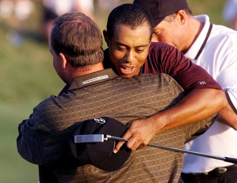 Tiger Woods hugs Bob May on the 18th hole after victory. Photograph: Jeff Haynes/AFP via Getty