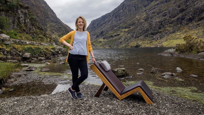 Furniture designer Tricia Harris with her chair the Lazy Lounger  in The Gap of Dunloe, Killarney. Photograph: Don MacMonagle