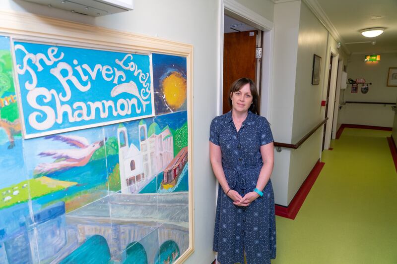 Stella Maris nursing home co-owner Clare McNally beside artworks created by residents. Photograph: Barry Cronin 