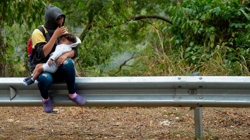 Venezuelan migrants rest as they walk on the road from Cúcuta to Pamplona in Colombia. The Venezuelan army has blockaded the Tienditas Bridge over which aid is supposed to pass. Photograph: Raul Arboleda/AFP