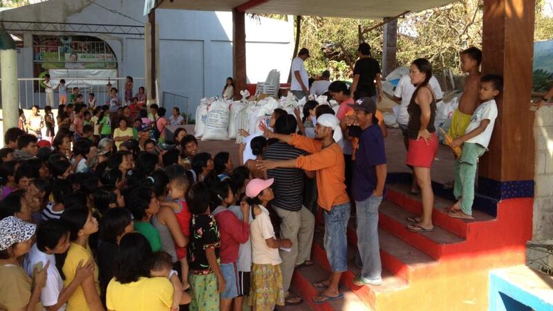 Villagers queue for rice  in the village of IIlihan on Cebu Island in the Philippines. Photograph: Peter Murtagh