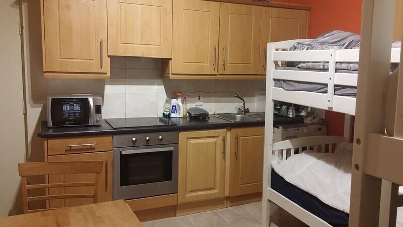An unidentified property advertised in a social media group with bunk beds in the kitchen of the property.