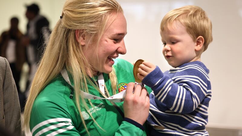 Boxer Amy Broadhurst meeting her nephew Zach after arriving back at Dublin Airport. Photograph: Dara Mac Donaill / The Irish Times