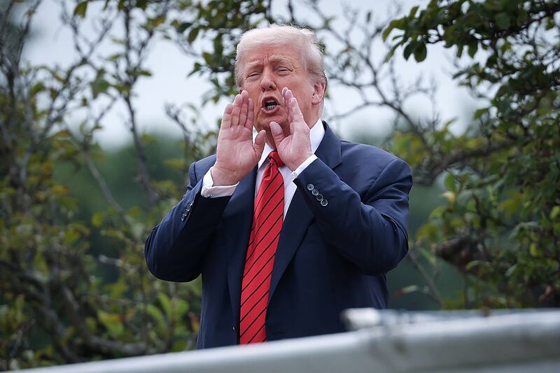 President Donald Trump shouts answers to questions from reporters as he tours the roof of the West Wing of the White House. Photograph:  Win McNamee/Getty Images