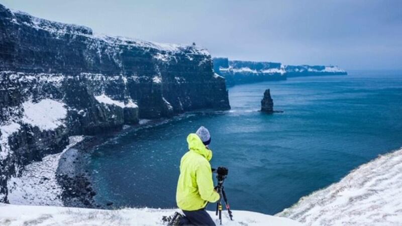 Cliffs of Moher: Kev L Smith takes a photograph in the snow on March 3rd, 2018