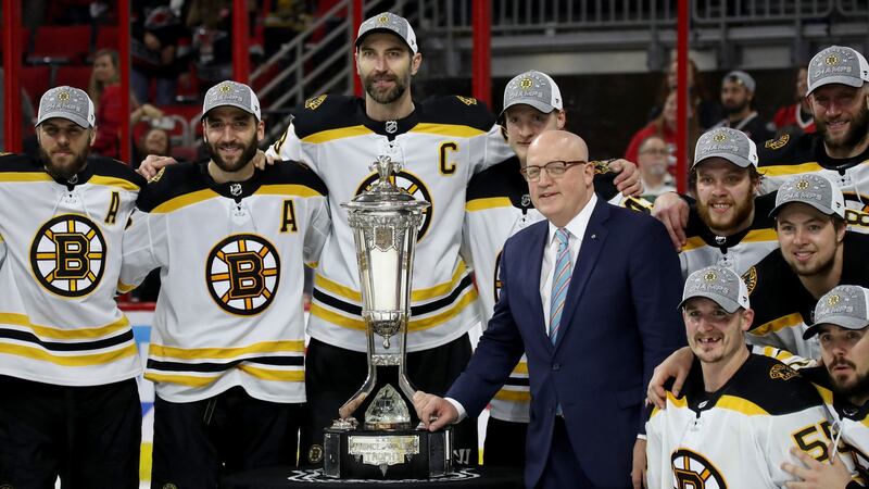 Chara and his teammates with the Deputy Commissioner Bill Daly and the Prince of Wales Trophy after winning the Eastern Conference Finals. Photo: Bruce Bennett/Getty Images