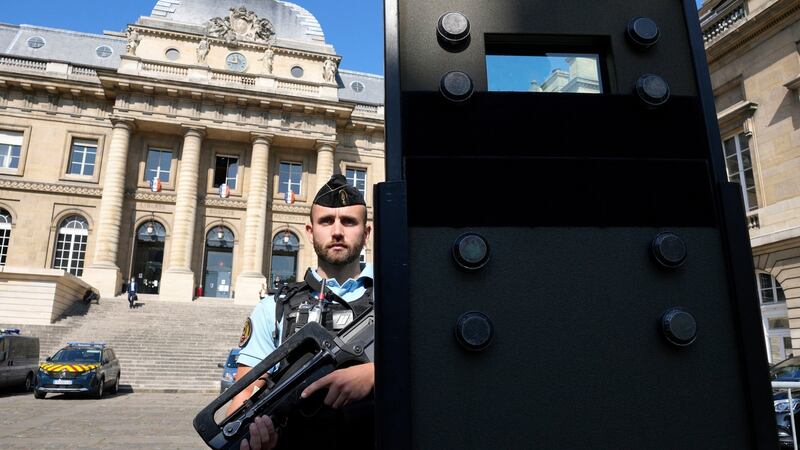 A police officer behind a shield outside the Paris courthouse last week. Photograph: Francois Mori/AP Photo