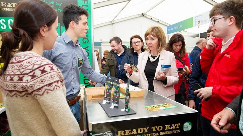 Recipe for success: Presidential hopeful Joan Freeman talks with Maurice Allshire and Laura Ahern of Rosscarbery Recipes  on the first day of the National Ploughing Championships in Screggan, Co Offaly. Photograph: Joe Keogh