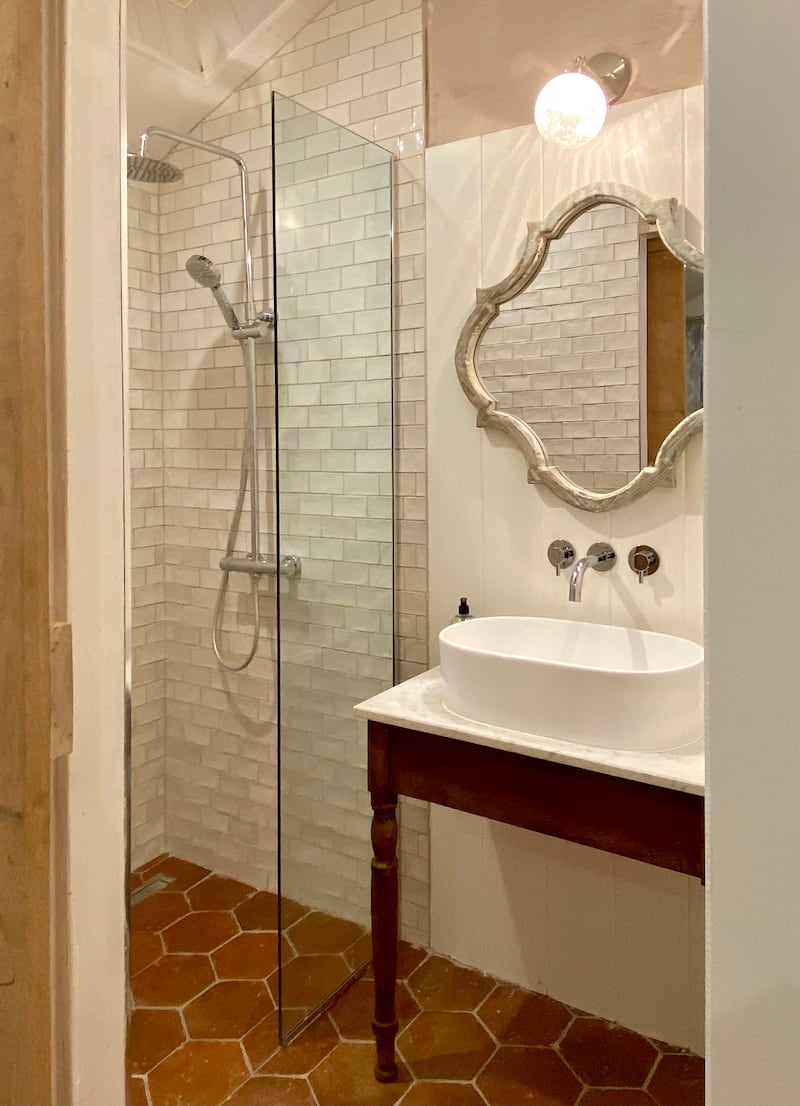 In the ensuite, the elegant console is actually a second-hand desk, sawn in two and topped with marble from a Clonakilty scrap yard