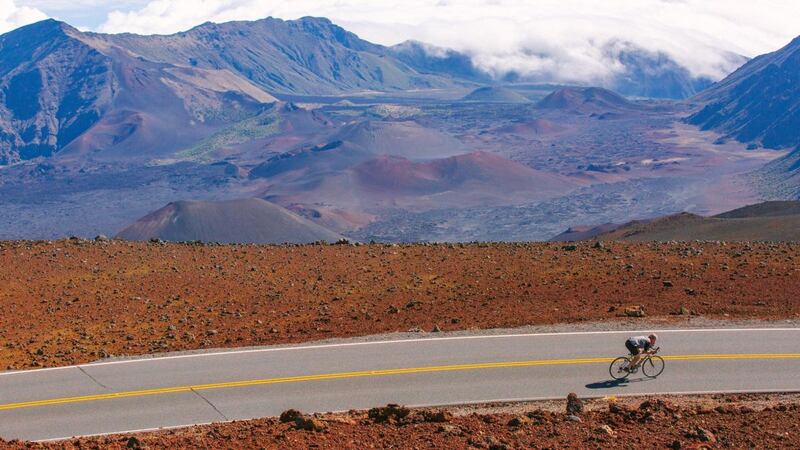 John Dunbar, one of the original founders of the Ironman Triathlon, biking along the road to the summit of Haleakala, Hawaii in December, 2018. Photograph: Michelle Mishina-Kunz/New York Times