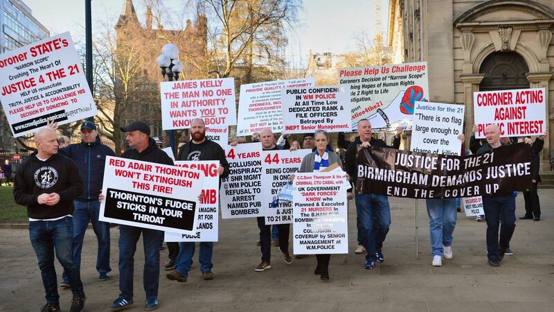 Supporters carry placards in St. Philip’s Cathedral Square before arriving at Birmingham Civil Justice centre. Photograph:  Anthony Devlin/Getty Images