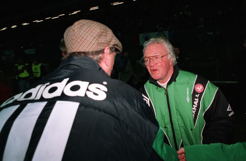 Billy Bingham, the most successful manager of Northern Ireland's football team, shakes hands with his Republic of Ireland counterpart Jack Charlton at Windsor Park in 1990. 