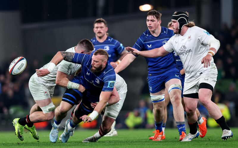 Leinster's RG Snyman offloads in a tackle from Ulster's Nick Timoney in Saturday's match at the Aviva. Photograph: Ben Brady/Inpho