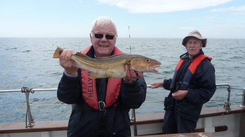 Ed Higo with a 2kg codling during the Irish Times’ outing to Hook Head, alongside Charlie Gannon