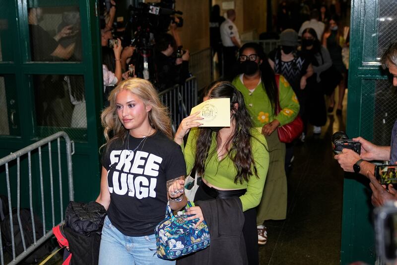 Members of the public, including a woman in a 'Free Luigi' T-shirt, enter a courtroom before Luigi Mangione is escorted in on Tuesday. Photograph: (Seth Wenig/AP